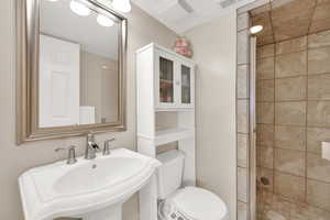 Bathroom featuring a stall shower and a sink