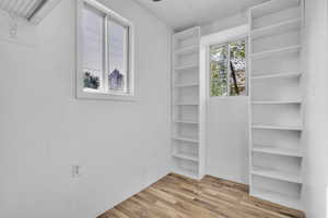Spacious closet with wood finished floors in primary bedroom