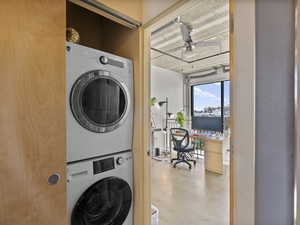 Laundry area featuring stacked washer / dryer and ceiling fan
