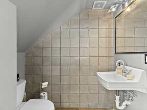 Bathroom featuring tile walls