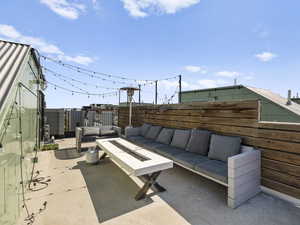 Fenced backyard with an outdoor living space with a fire pit and a patio
