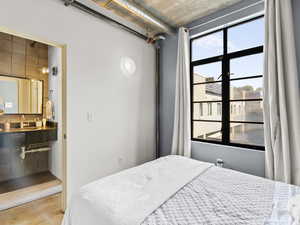 Bedroom with ensuite bath and concrete floors