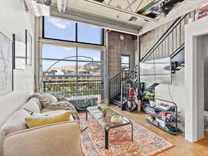 Living room featuring concrete flooring and stairs