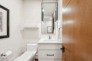 Half bath featuring toilet and vanity