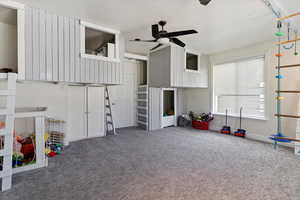 Rec room with ceiling fan and carpet