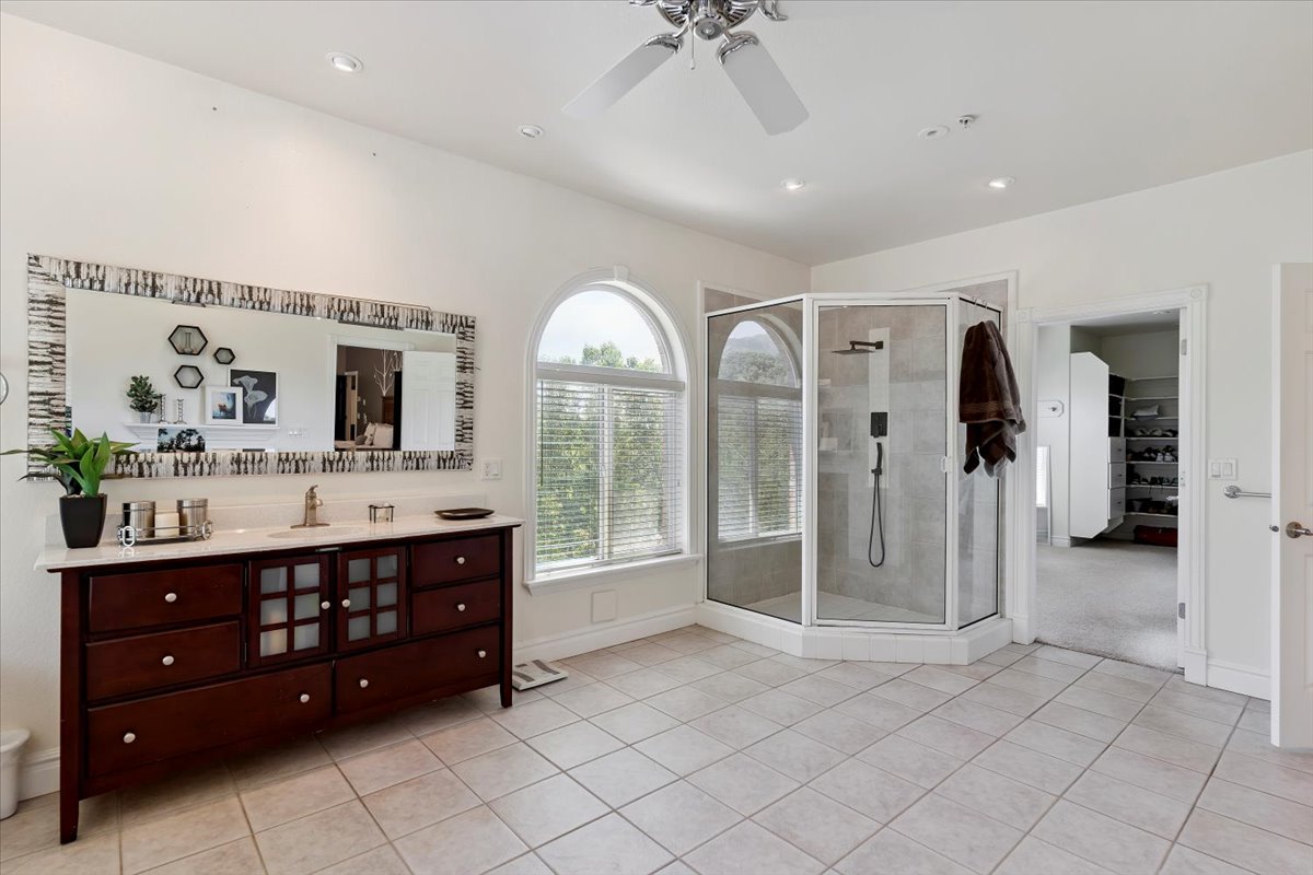 Full bathroom with tile patterned flooring, vanity, a stall shower, ceiling fan, and recessed lighting
