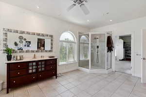 Full bathroom with tile patterned flooring, vanity, a stall shower, ceiling fan, and recessed lighting