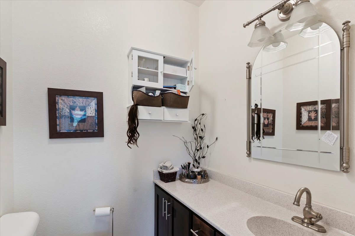 Half bath featuring toilet and vanity