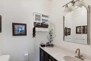 Half bath featuring toilet and vanity