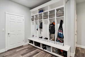 Mudroom featuring wood finished floors and baseboards