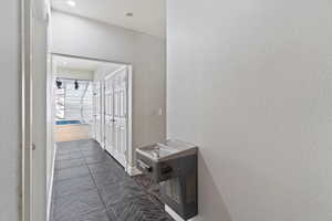 Hall with dark tile patterned floors