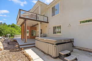 Patio / terrace featuring a hot tub, ceiling fan, a deck, and a patio