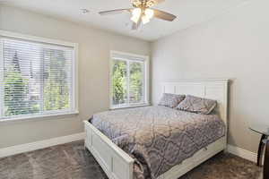 Bedroom featuring dark colored carpet and ceiling fan
