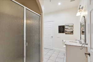 Full bath featuring tile patterned flooring, vanity, a stall shower, and recessed lighting