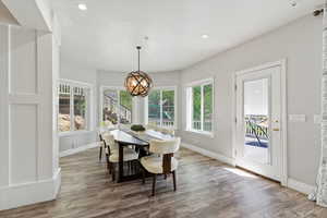 Dining space featuring a chandelier, plenty of natural light, wood finished floors, and recessed lighting