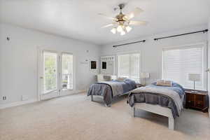 Bedroom with access to outside, carpet floors, multiple windows, and ceiling fan