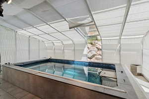 View of pool with a hot tub