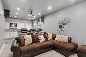 Cinema room with recessed lighting and light carpet