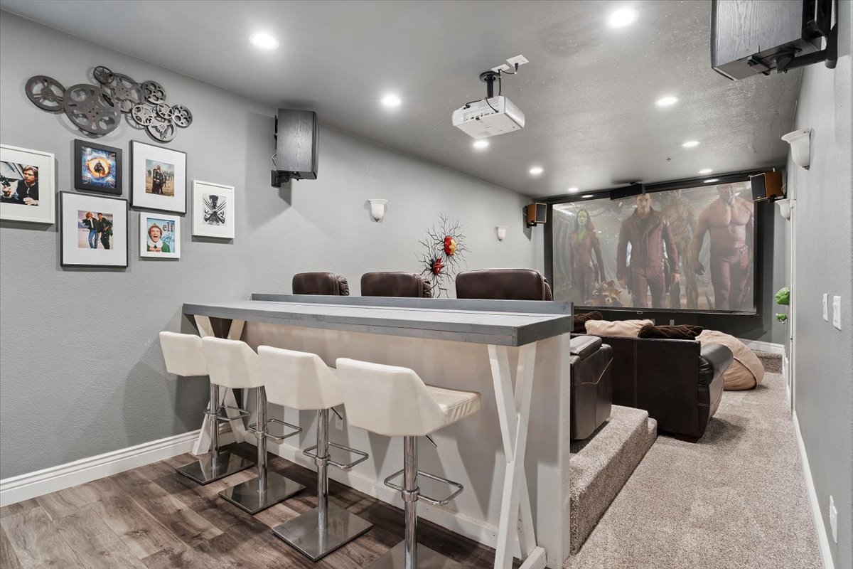 Home theater room with recessed lighting and wood finished floors