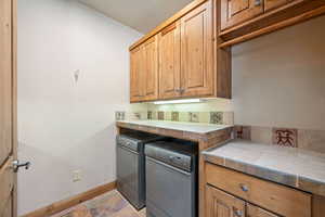 Kitchen featuring tile countertops and brown cabinetry