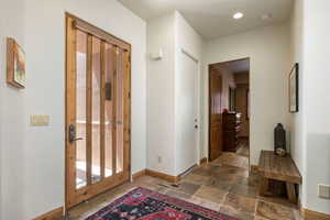 Entrance foyer featuring stone tile floors and recessed lighting