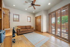 Home office featuring a ceiling fan, healthy amount of natural light, light wood-type flooring, and recessed lighting