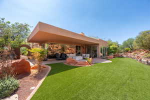 Rear view of house with a patio area, a yard, an outdoor living space, and a chimney