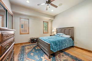 Bedroom with light wood-type flooring, recessed lighting, and ceiling fan
