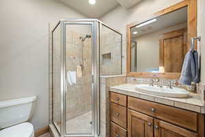 Bathroom featuring vanity, a stall shower, and recessed lighting