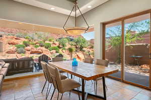 Dining area featuring stone tile floors and recessed lighting