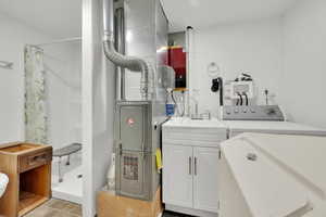Laundry room featuring washer / clothes dryer  inside detached garage