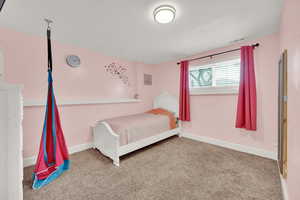 Bedroom with carpet floors and baseboards