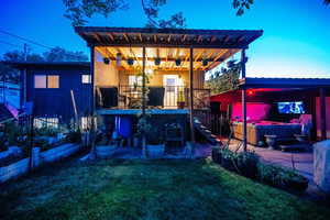 Rear view of property featuring a hot tub and board and batten siding