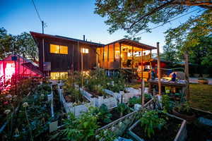 Back of house featuring a vegetable garden