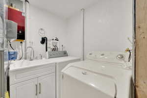 Laundry area with separate washer and dryer inside detached garage