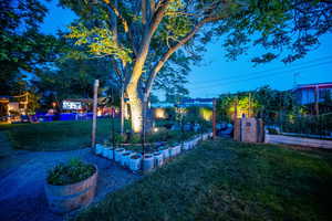View of grassy yard featuring a garden