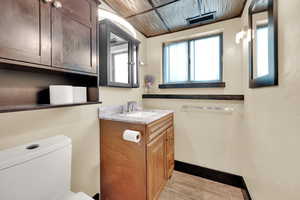 basement Half bath featuring tile  floors and vanity