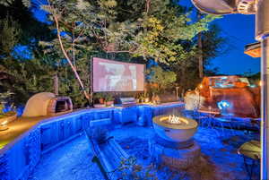 fire pit, an outdoor water feature, a grill, and a patio