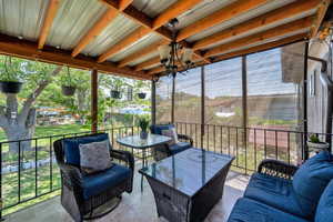 Sunroom featuring a chandelier and outdoor lounge area