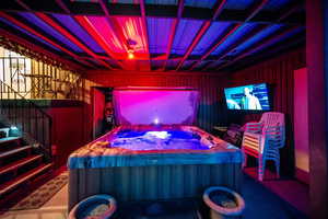 View of patio / terrace featuring a hot tub and stairway