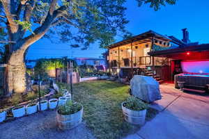 View of yard featuring a hot tub and stairs