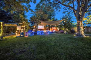 Fenced backyard featuring a playground