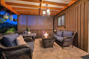 Deck  featuring an outdoor living space with a fire pit and a chandelier