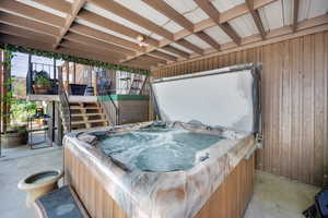 View of patio with stairway and a hot tub