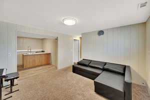 Second Kitchen &  living room featuring light colored carpet and tile.