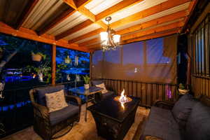 View of patio with an outdoor fire pit