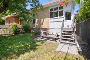 Back of house featuring brick siding and a fenced backyard