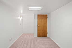 Carpeted spare room with baseboards