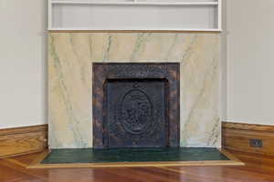 Detailed view of a tile fireplace and wood finished floors