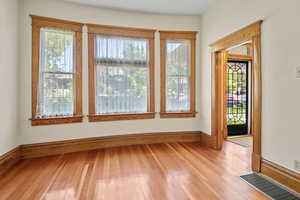 Unfurnished room with light wood finished floors and plenty of natural light